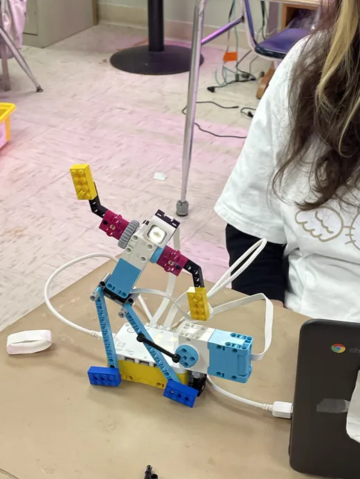 A student-built robotics model wired up to a laptop in the STEM lab