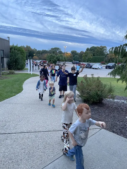 Families walking together across campus at SCA Family Night