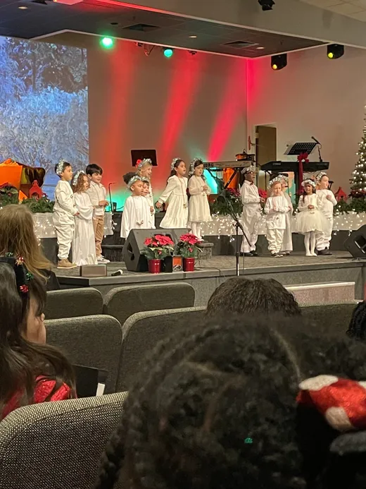 Younger students in costume performing in the Christmas production
